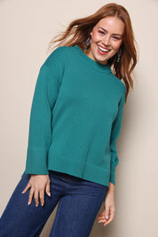 Model Georgiel wearing size 10 of the Cotton Wool Cashmere Jumper – Teal in colour Teal, in a cropped view