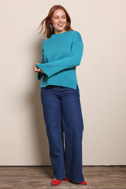 Model Georgiel wearing size 10 of the Cotton Wool Cashmere Jumper – Teal in colour Teal, from the front