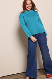 Model Georgiel wearing size 10 of the Cotton Wool Cashmere Jumper – Teal in colour Teal, from the front