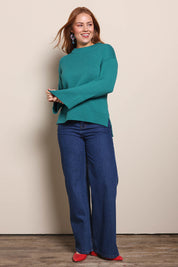 Model Georgiel wearing size 10 of the Cotton Wool Cashmere Jumper – Teal in colour Teal, from the front