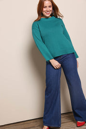 Model Georgiel wearing size 10 of the Cotton Wool Cashmere Jumper – Teal in colour Teal, from the front