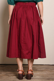 Model Georgiel wearing size 10 of the Cotton Blend Midi Skirt – Burgundy in colour Burgundy, from the back