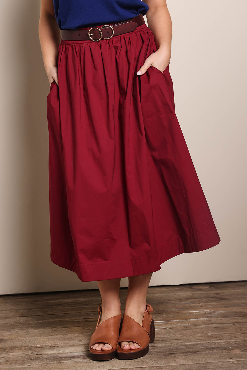 Model Georgiel wearing size 10 of the Cotton Blend Midi Skirt – Burgundy in colour Burgundy, in a cropped view