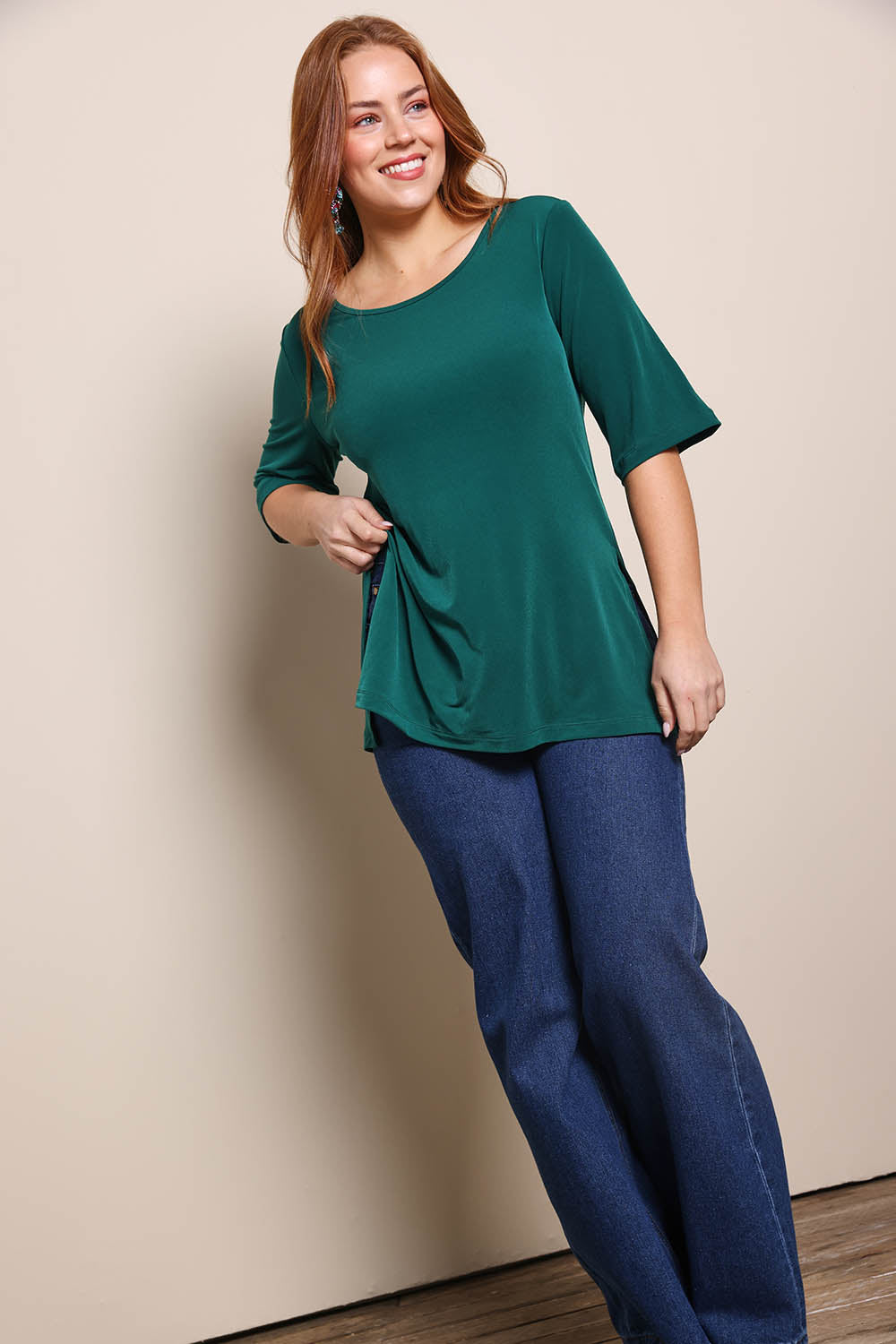 Model Georgiel wearing size 10 of the Side Split Tunic Top – Posygreen in colour Posygreen, from the front