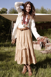 A model wearing the Louise Genuine Leather Belt in colour Tan, from the front, showing the whole outfit