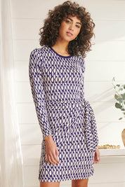 A model wearing the Wrap Dress in colour Geometric (Blue), from the front, showing the whole outfit