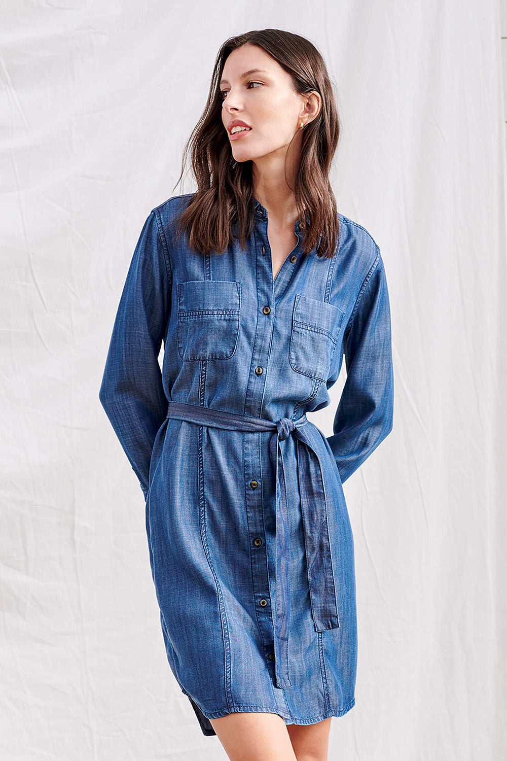 A model wearing the Riley Shirt Dress in colour Denim (Blue), from the front, cropped image