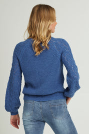 Model Grace wearing size S of the Floral Knit Sweater in colour Ampblue (Blue), from the back