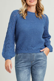 Model Grace wearing size S of the Floral Knit Sweater in colour Ampblue (Blue), from the front, cropped image