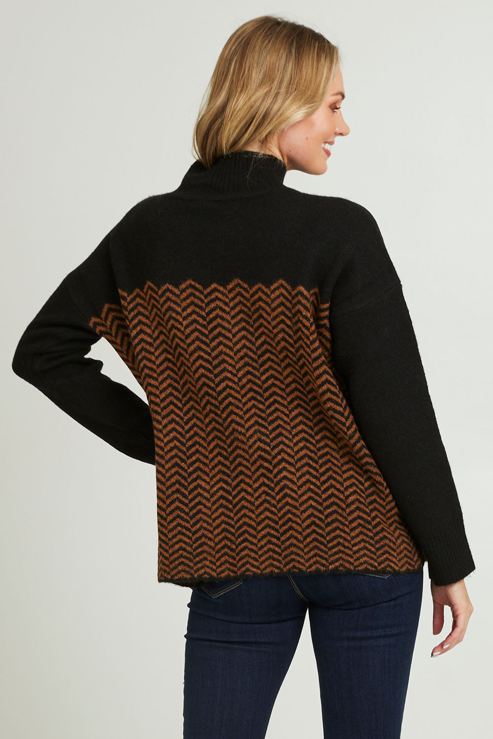 Model Grace wearing size S of the Mock Neck Tunic in colour Herrbone, from the back