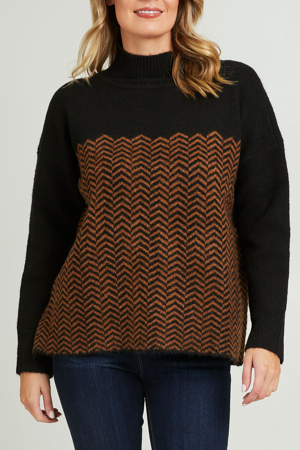 Model Grace wearing size S of the Mock Neck Tunic in colour Herrbone, from the front, cropped image