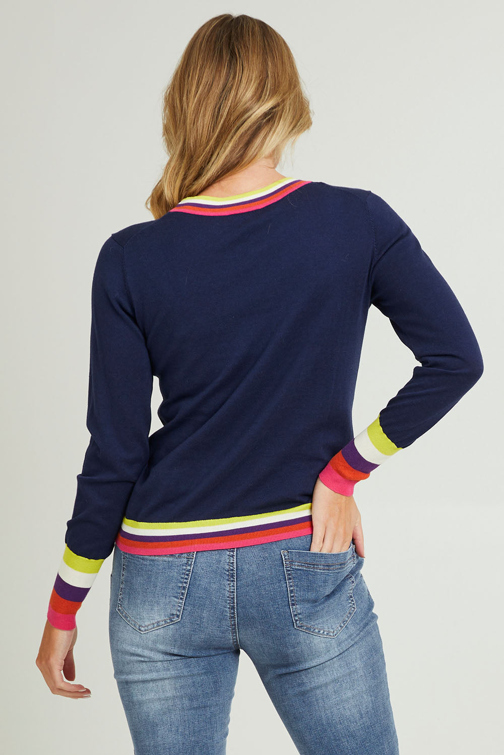 Model Grace wearing size S of the Emma Sweater in colour Rainbowstp (Blue), from the back