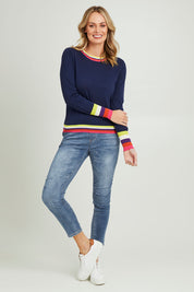 Model Grace wearing size S of the Emma Sweater in colour Rainbowstp (Blue), from the front, showing the whole outfit