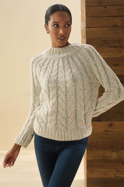 A model wearing the Dylan Cable Knit Sweater in colour Rainbow, from the front, showing the whole outfit