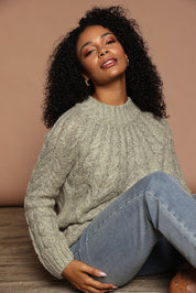 Model Ziara wearing size S of the Dylan Cable Knit Sweater in colour Moss (Green), from the front, showing the whole outfit