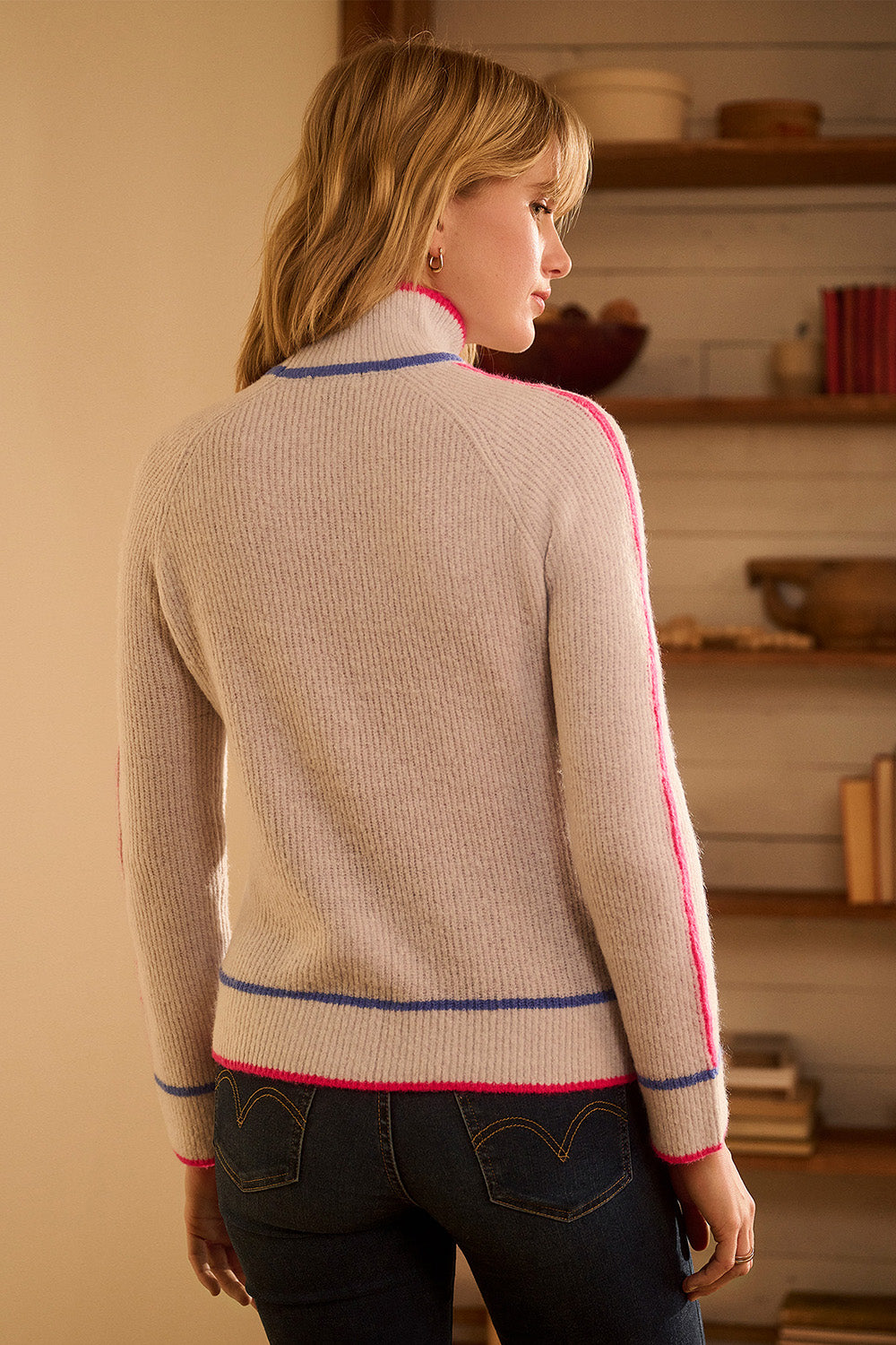 A model wearing the Raglan Pullover Jumper in colour Palesnow, from the back