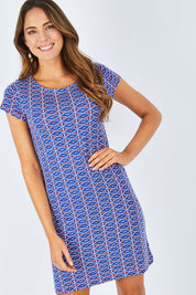Model Madeline wearing size S of the Nellie Triangle Stamps Dress in colour Bluecrush (Blue), from the front, cropped image
