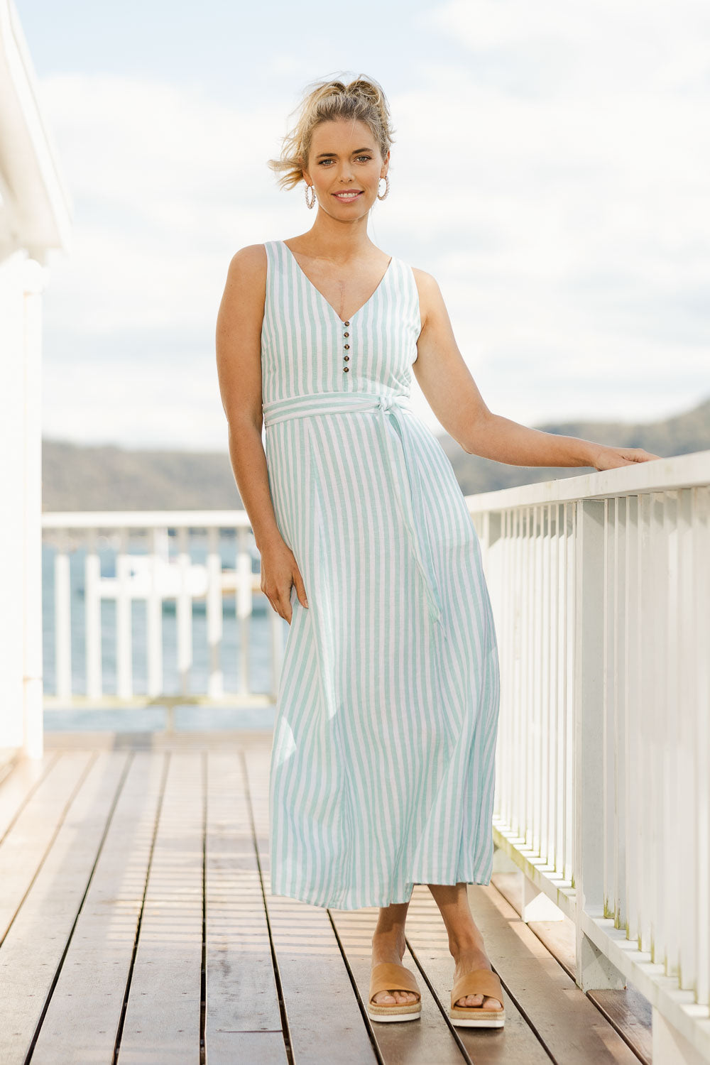 Model Phoebe wearing size S of the Isla Maxi Dress in colour Turquoise (Green), from the front, showing the whole outfit