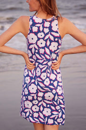 A model wearing the Bella Dress in colour Flowers (Blue), from the back