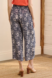 A model wearing the Cassie Pants in colour Floral (Blue), from the back