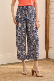 A model wearing the Cassie Pants in colour Floral (Blue), from the front, cropped image