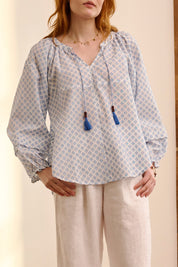 A model wearing the Naomi Cotton Blend Blouse in colour Petal (Blue), from the front, cropped image