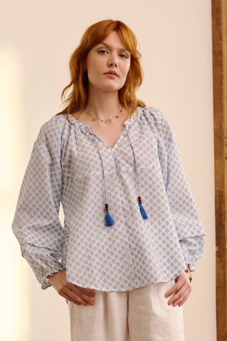 A model wearing the Naomi Cotton Blend Blouse in colour Petal (Blue), from the front, cropped image