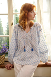 A model wearing the Naomi Cotton Blend Blouse in colour Petal (Blue), from the front, showing the whole outfit