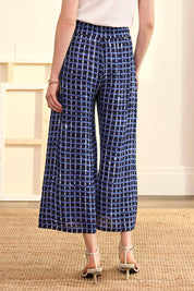 A model wearing the Cassie Pants in colour Plaid (Blue), from the back