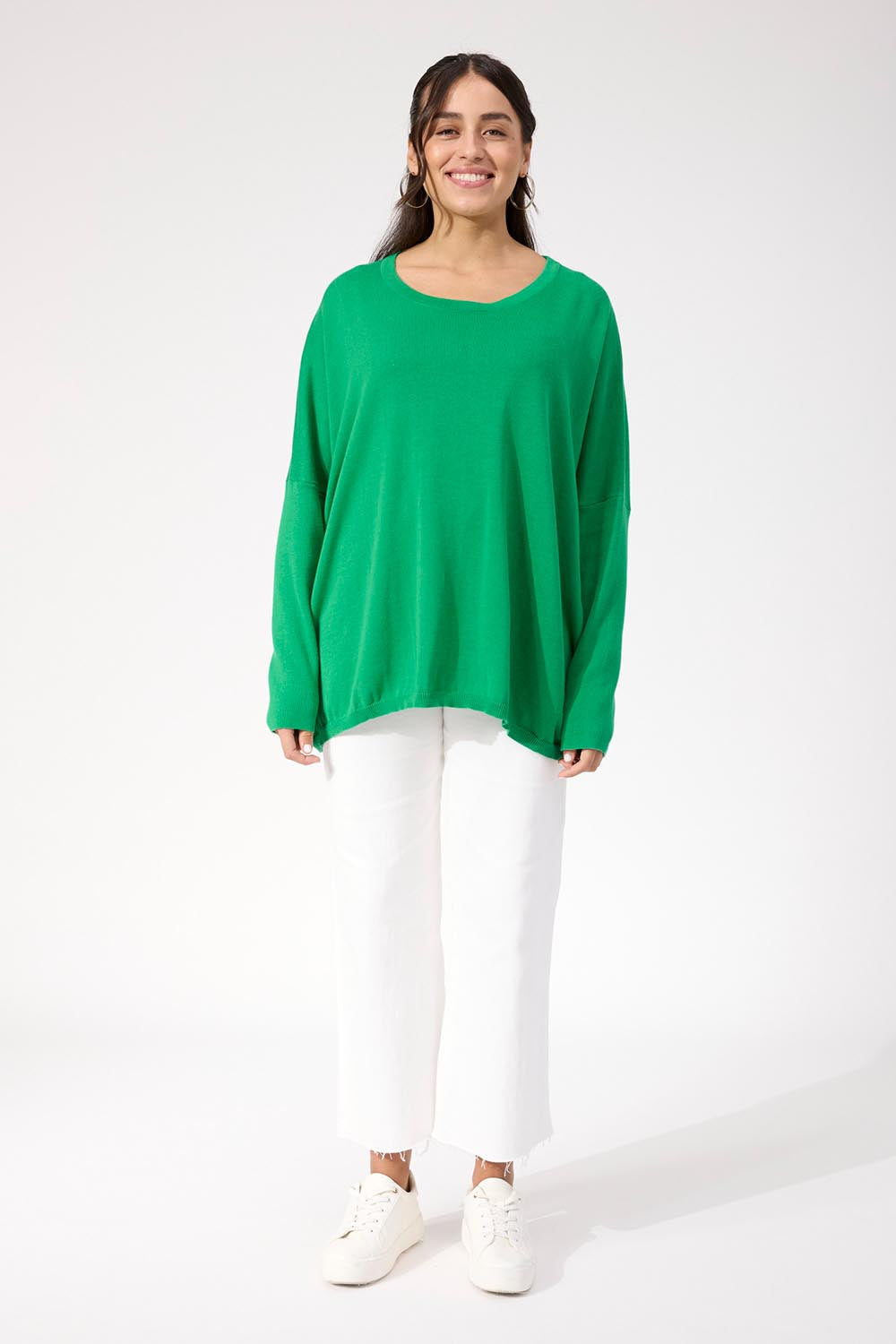 A model wearing the Haven Jumper in colour Oasis (Green), from the front, showing the whole outfit