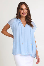 Model Madeline wearing size S of the Baja Top in colour Safira (Blue), from the front, cropped image