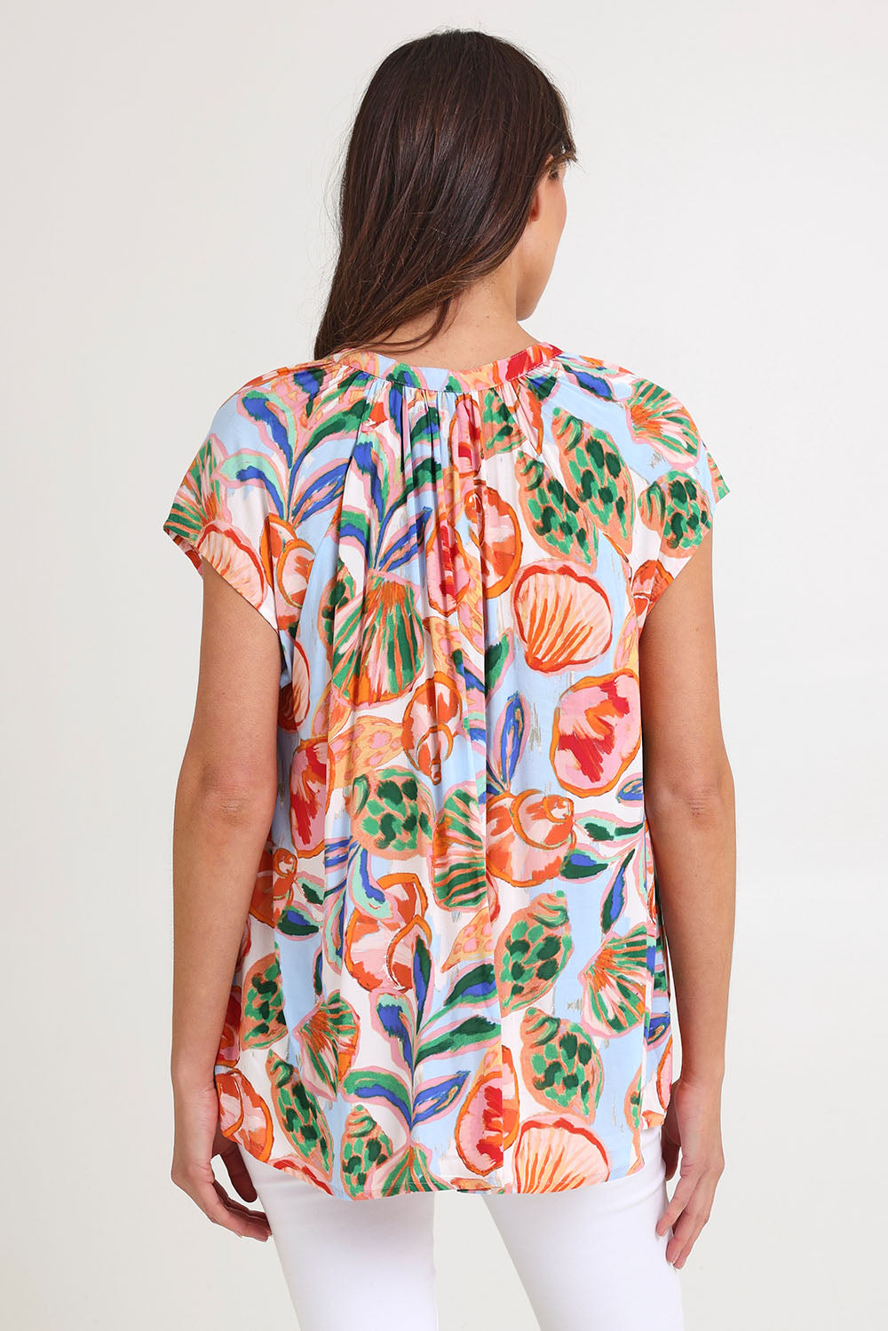 Model Madeline wearing size S of the Baja Top in colour Tide, from the back