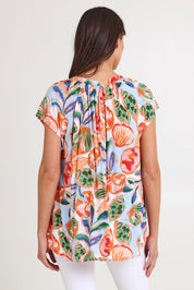 Model Madeline wearing size S of the Baja Top in colour Tide, from the back