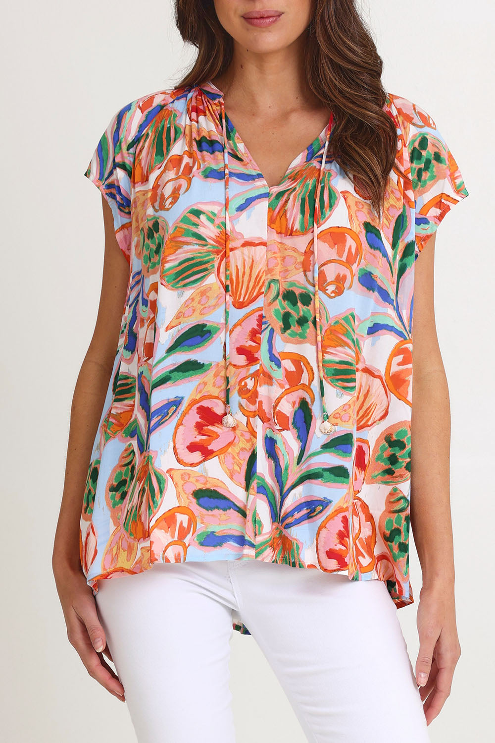 Model Madeline wearing size S of the Baja Top in colour Tide, from the front, cropped image
