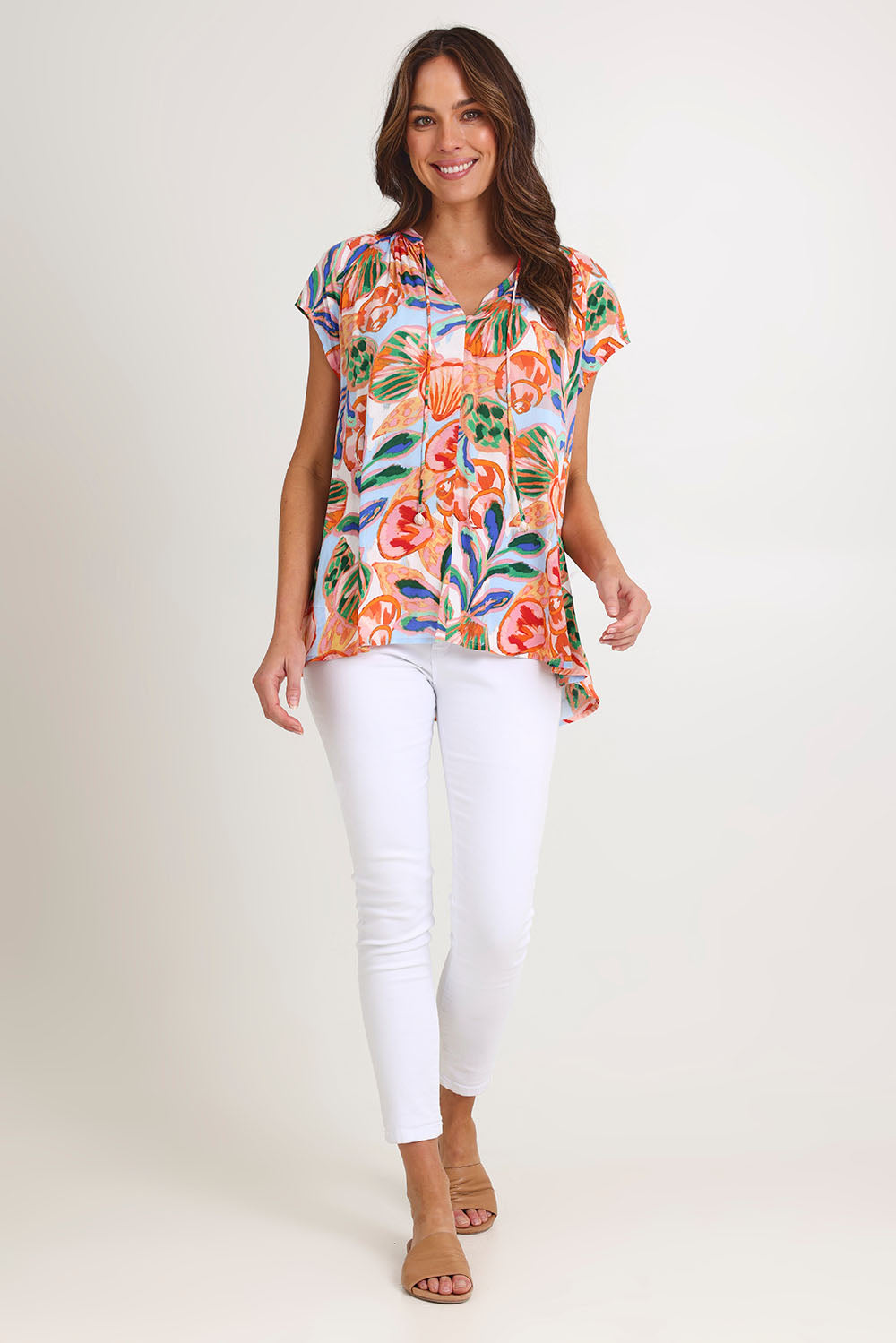 Model Madeline wearing size S of the Baja Top in colour Tide, from the front, showing the whole outfit