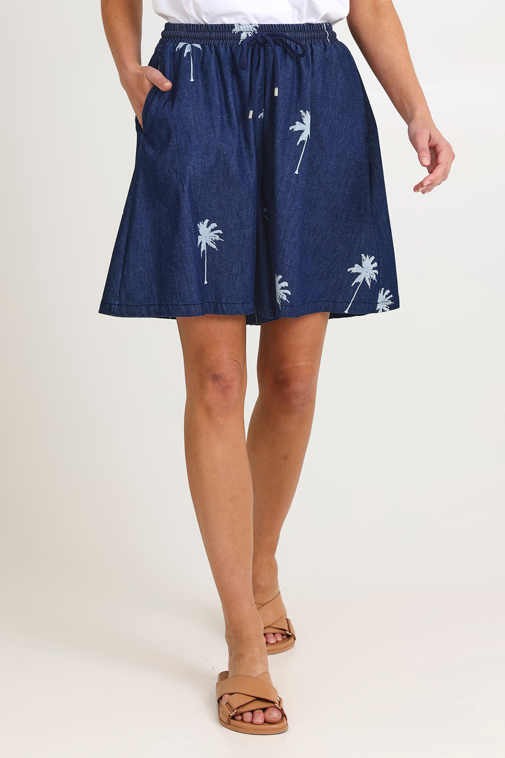 Model Madeline wearing size S of the Montego Denim Short in colour Indigo (Blue), from the front, cropped image