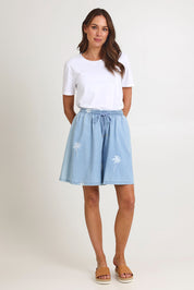 Model Madeline wearing size S of the Montego Denim Short in colour Safira (Blue), from the front, showing the whole outfit
