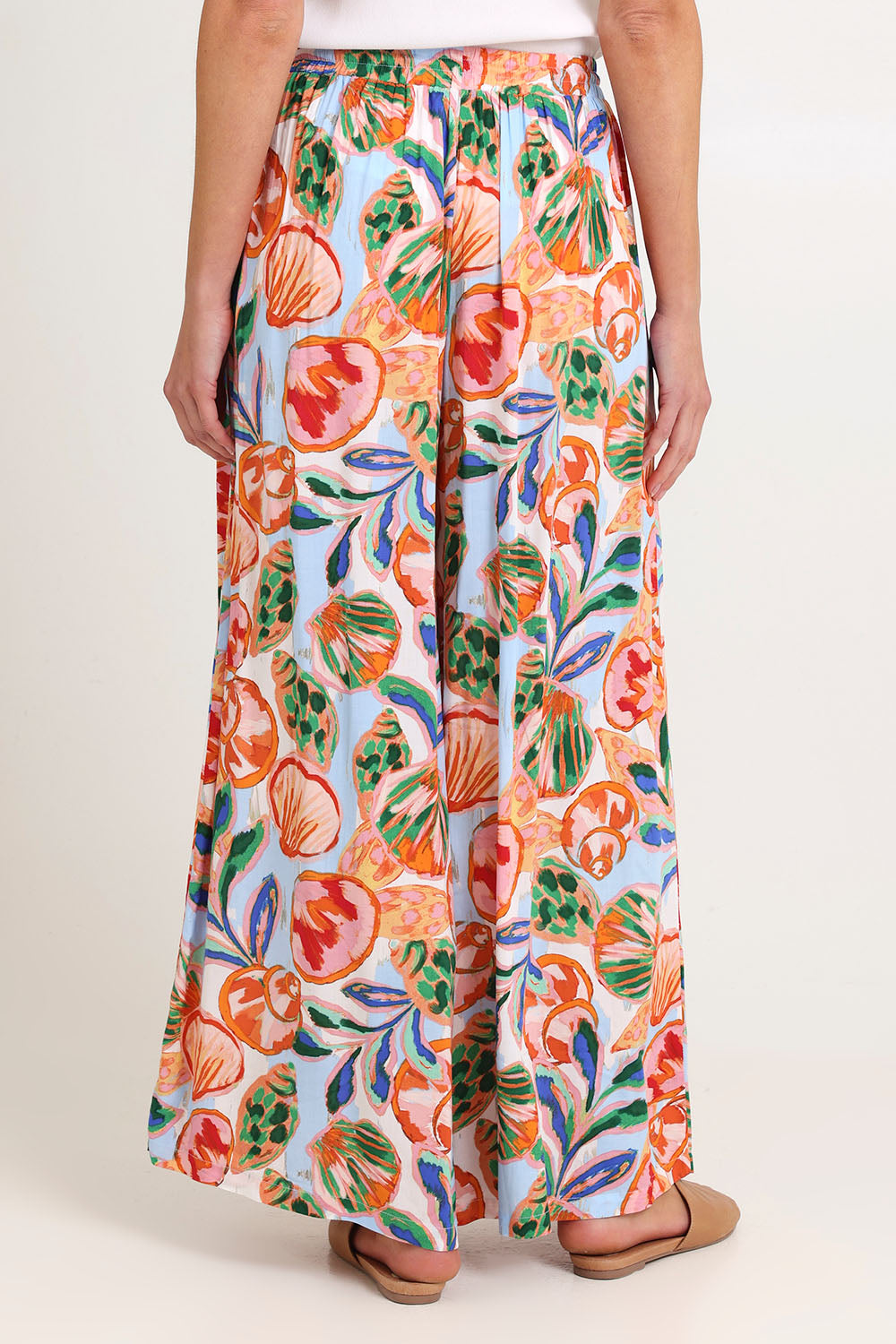 Model Madeline wearing size S of the Baja Pant in colour Tide, from the back