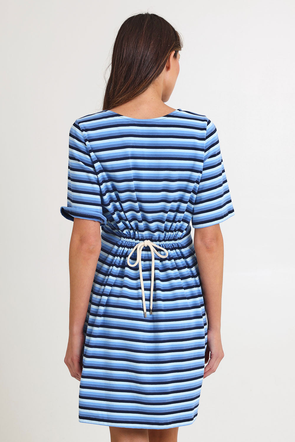 Model Madeline wearing size S of the Limon Stripe Cotton Tshirt Dress in colour Indigo (Blue), from the back