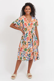 A model wearing the Baja Dress in colour Tide, from the front, showing the whole outfit