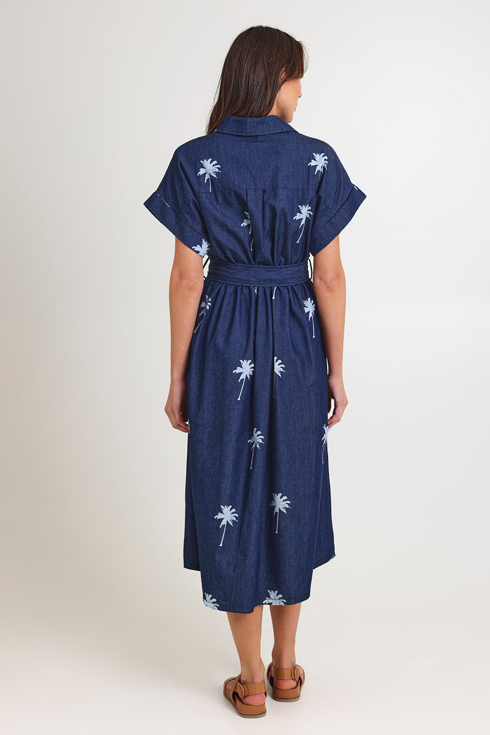 Model Madeline wearing size S of the Montego Denim Shirt Dress in colour Indigo (Blue), from the back
