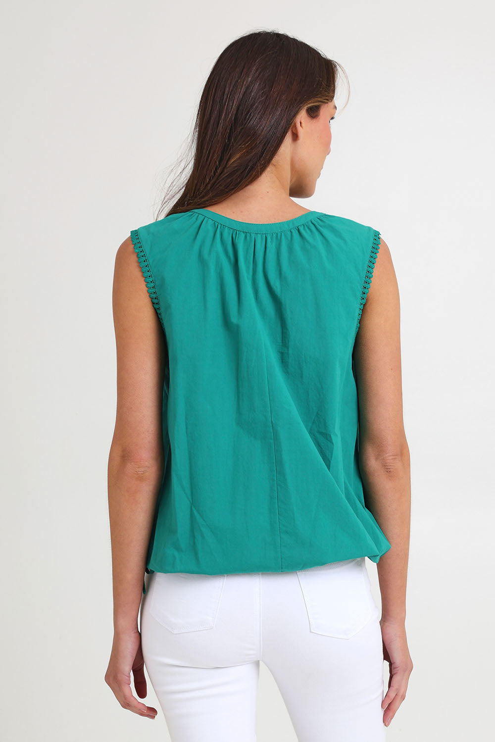 Model Madeline wearing size S of the Santos Cotton Top in colour Teal (Green), from the back