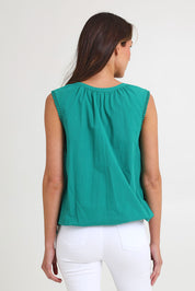 Model Madeline wearing size S of the Santos Cotton Top in colour Teal (Green), from the back