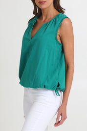 Model Madeline wearing size S of the Santos Cotton Top in colour Teal (Green), from the front, cropped image