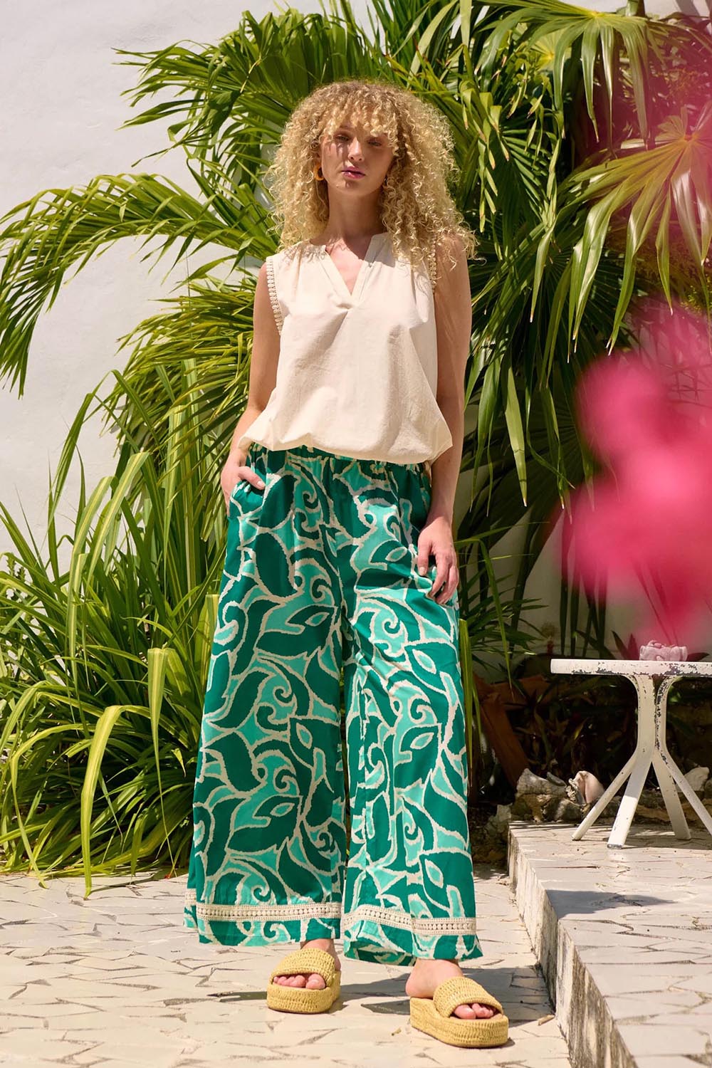 A model wearing the Santos Cotton Pant in colour Amazon (Green), from the front, showing the whole outfit