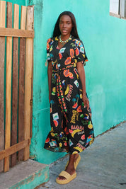 A model wearing the Cabana V Neck Maxi Dress in colour Brasilblk (Black), from the front, showing the whole outfit