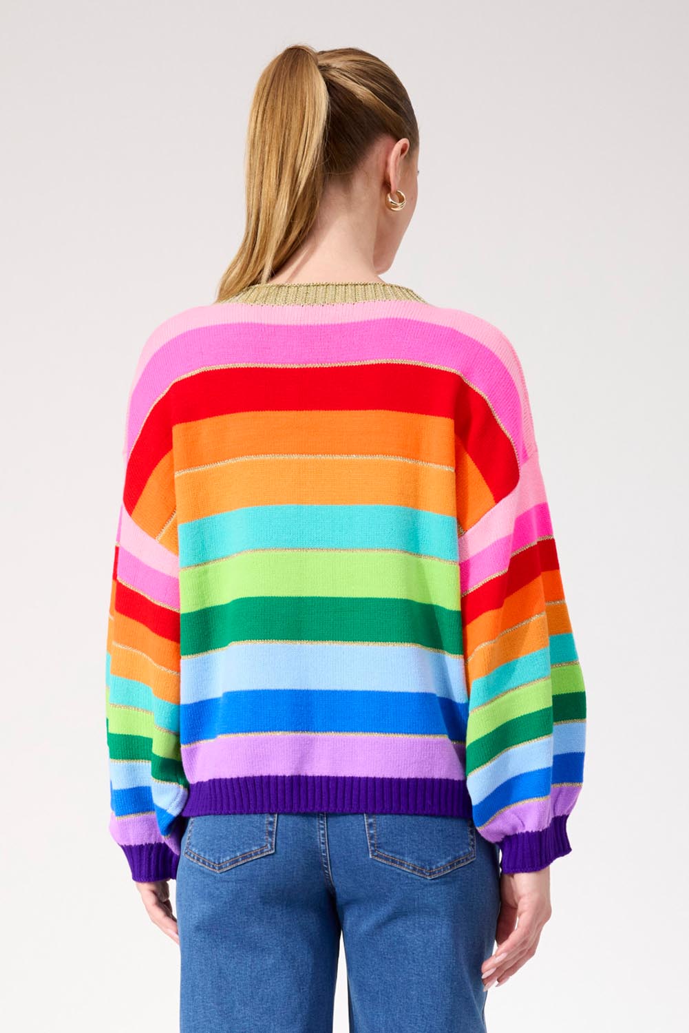 A model wearing the Niseko Jumper in colour Rainbow, from the front, cropped image