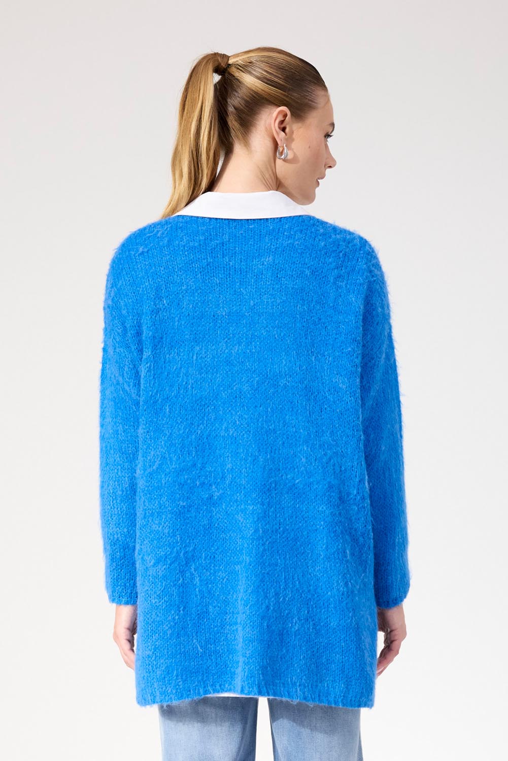 A model wearing the Lyon Relaxed Jumper in colour Cobalt (Blue), from the back