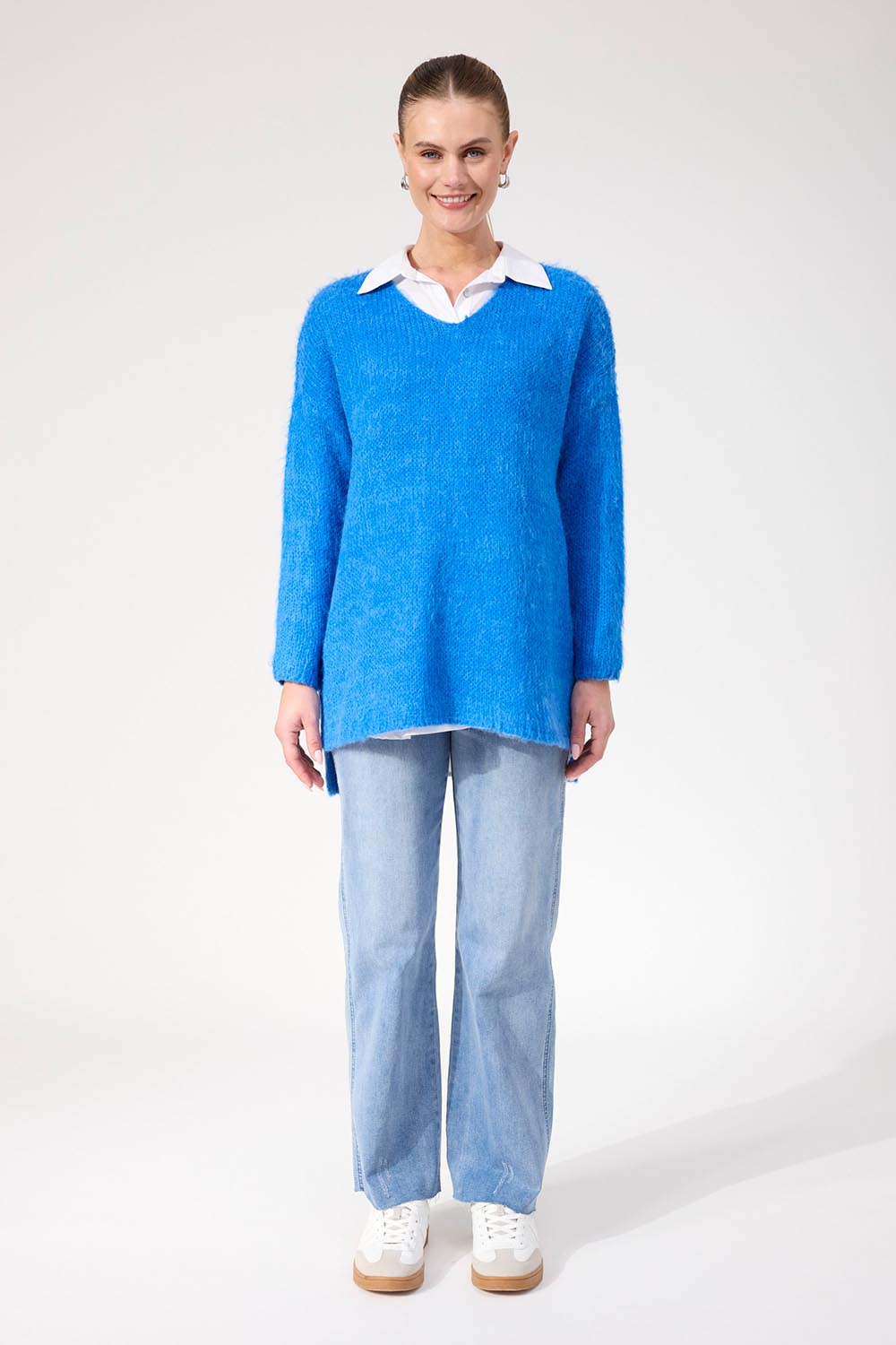 A model wearing the Lyon Relaxed Jumper in colour Cobalt (Blue), from the front, showing the whole outfit