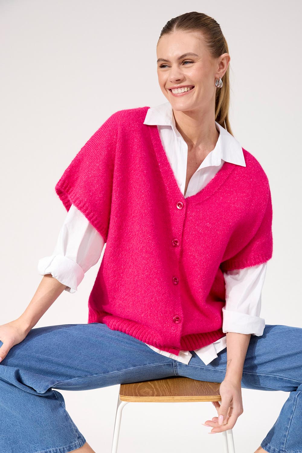 A model wearing the Valenza Knit Vest in colour Hotpink (Pink), from the front, cropped image